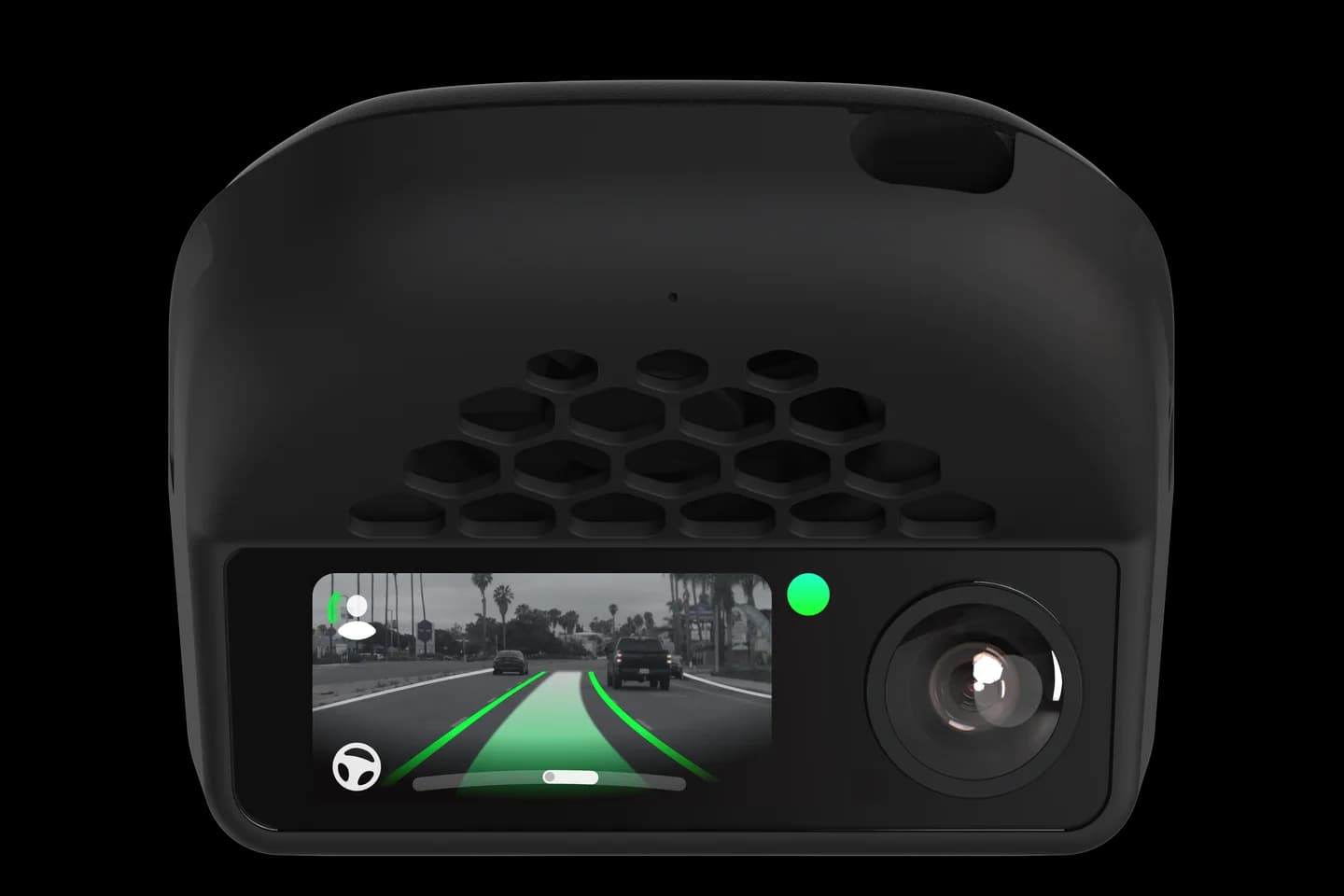 The comma four device with its screen showing the road ahead and a green driving path